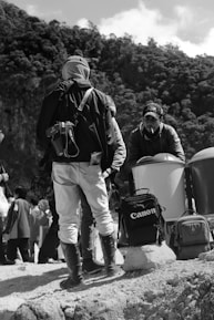 A group of diverse outdoor creators collaborating in nature.