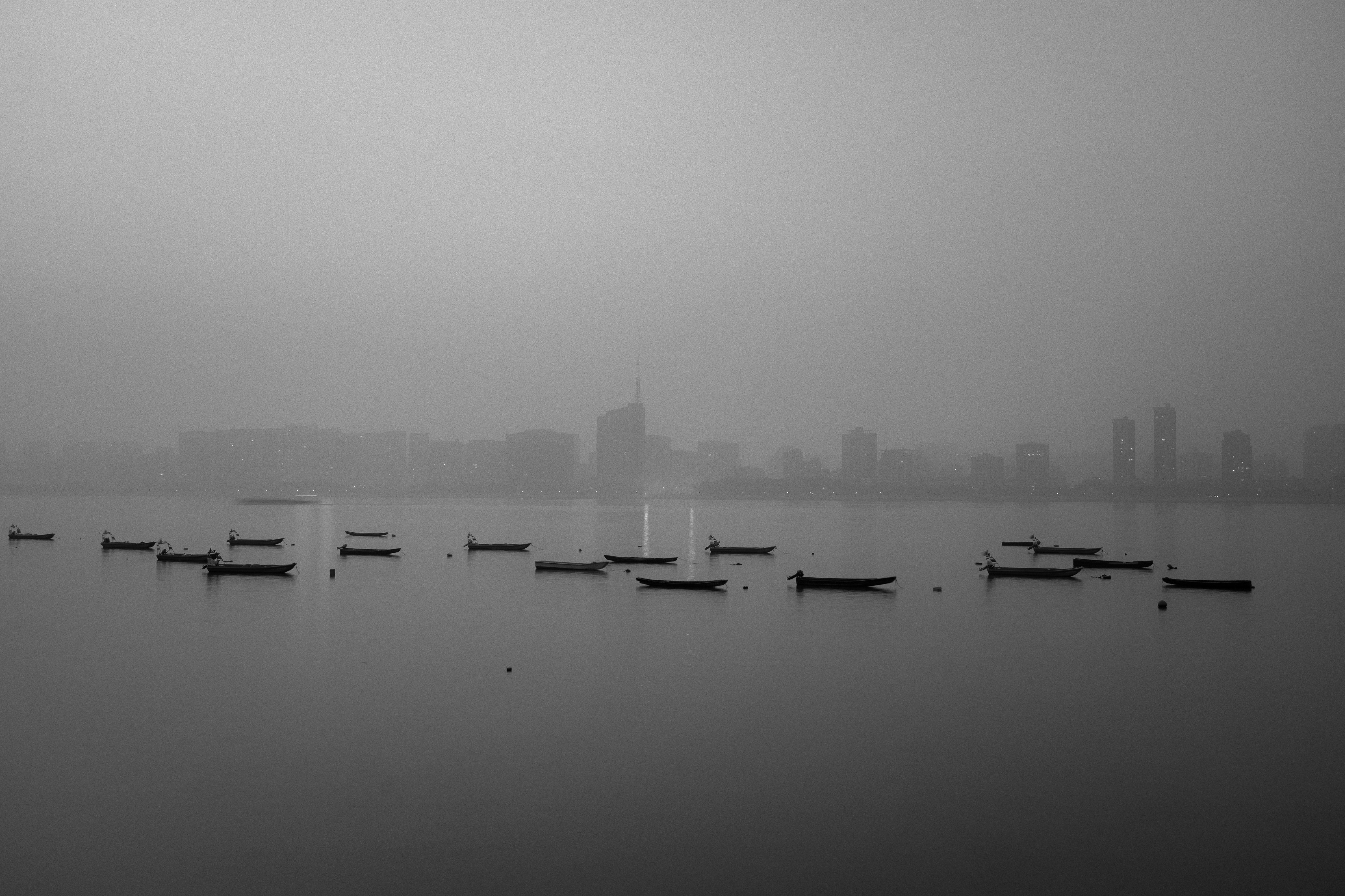 grayscale photography of boats on sea