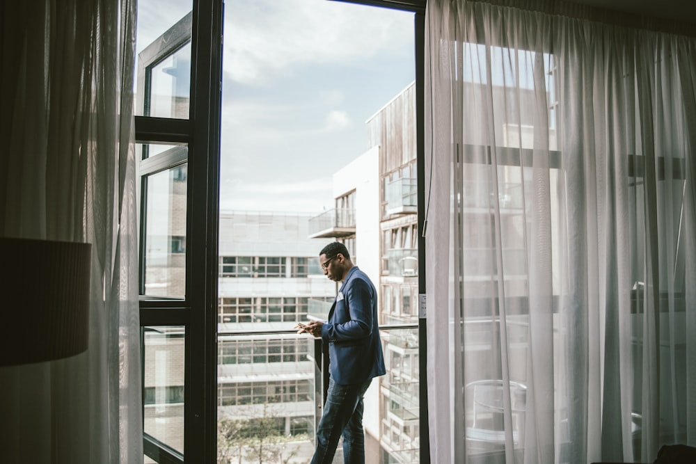 man in dress suit standing near door