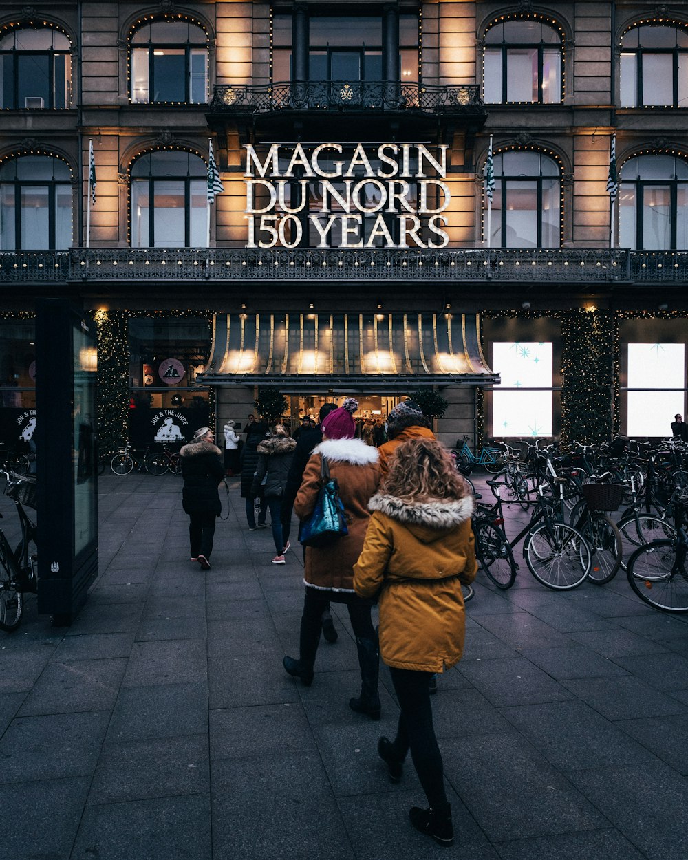 people walking towards Magasin Du Nord 150 Years