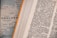 An open dictionary page with text in a foreign language, possibly German, showing various terms and their definitions. Next to it, a blurred map partially visible with the word 'ENGLAND' and parts of the coastline.