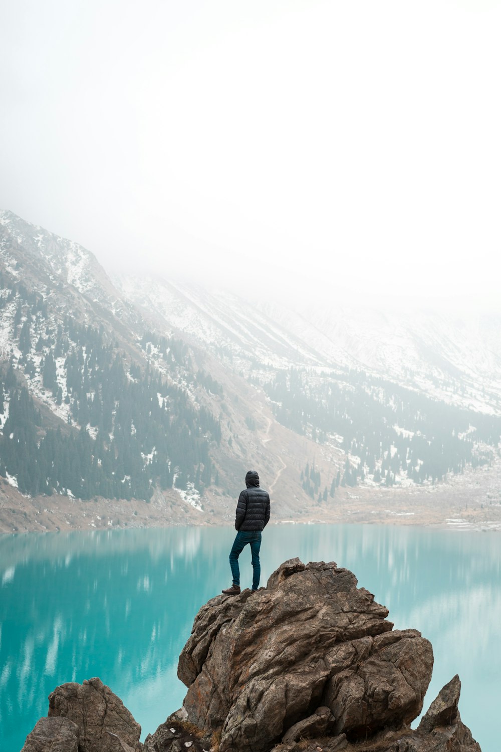 person standing on rock formation