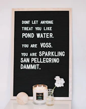 A warm, inviting workspace with a handwritten note and a glowing candle symbolizing hope and connection.