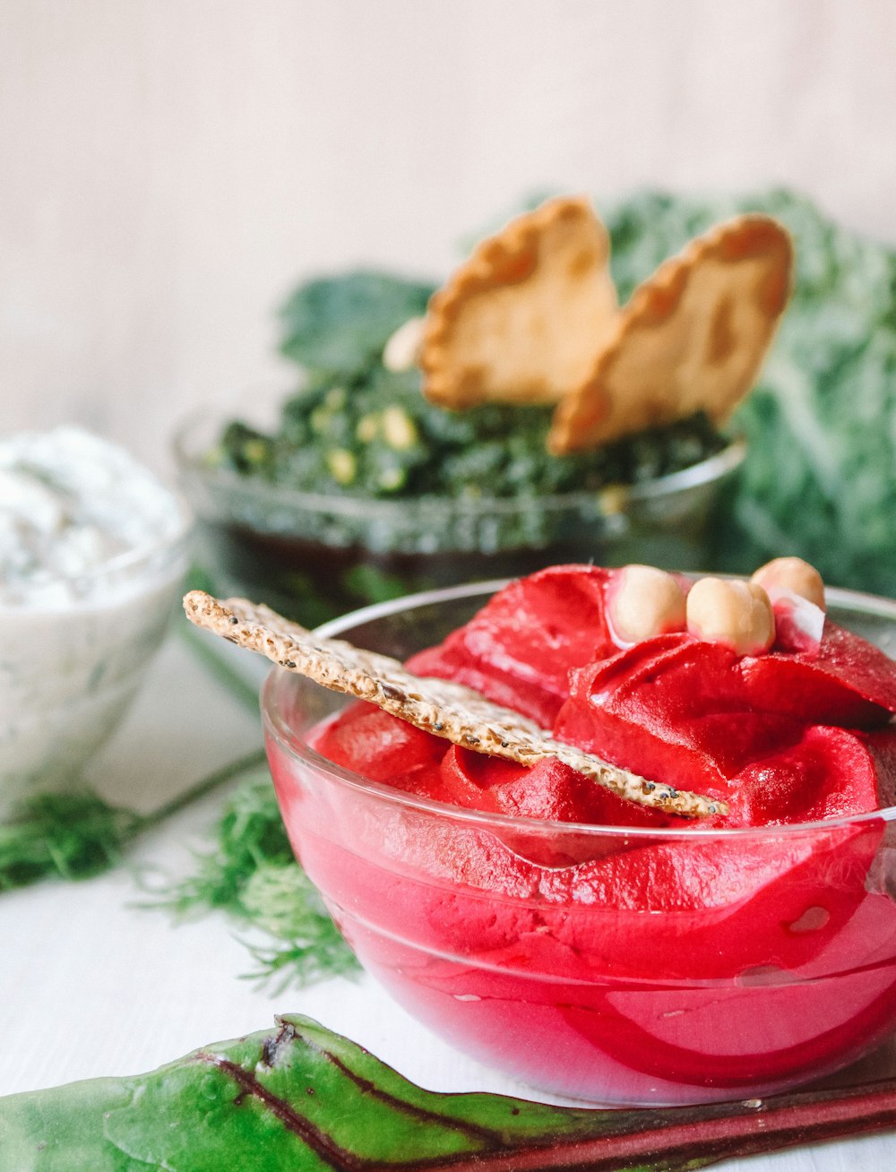 biscuit on red dip on round clear glass bowl