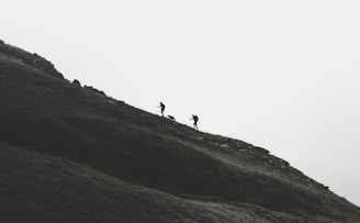 silhouette of person walking on mountain