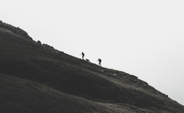 silhouette of person walking on mountain