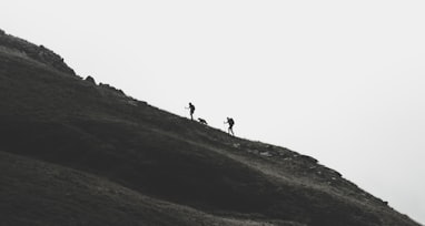 silhouette of person walking on mountain