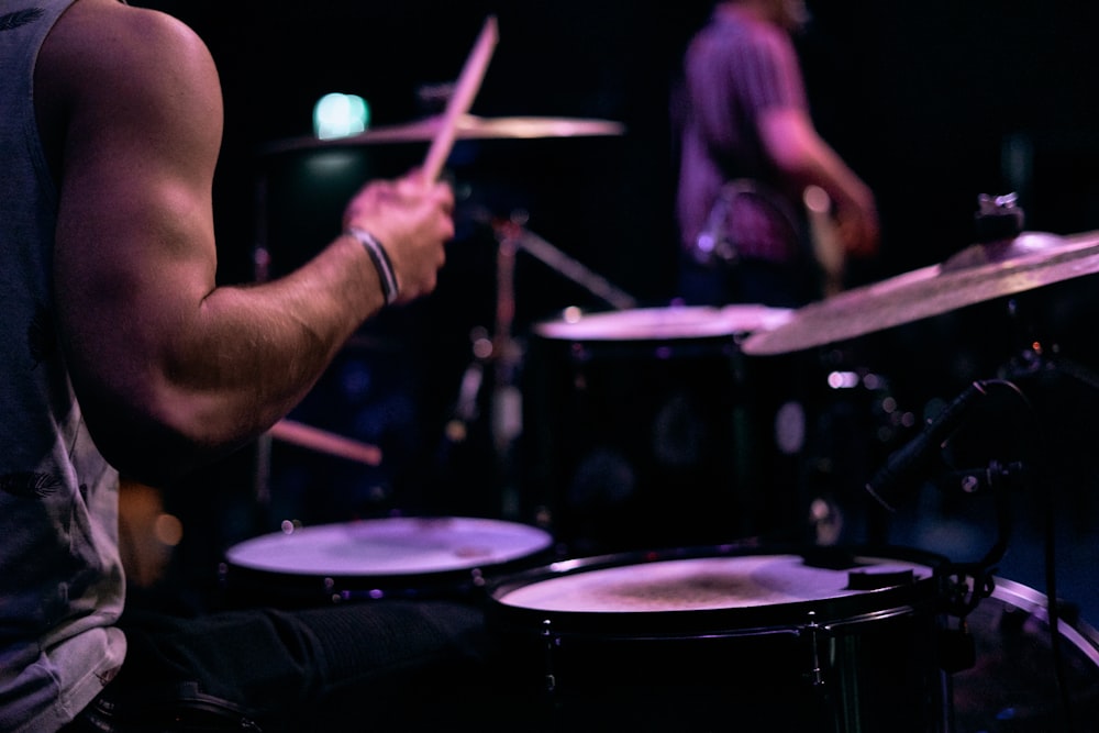 person playing drum and guitar