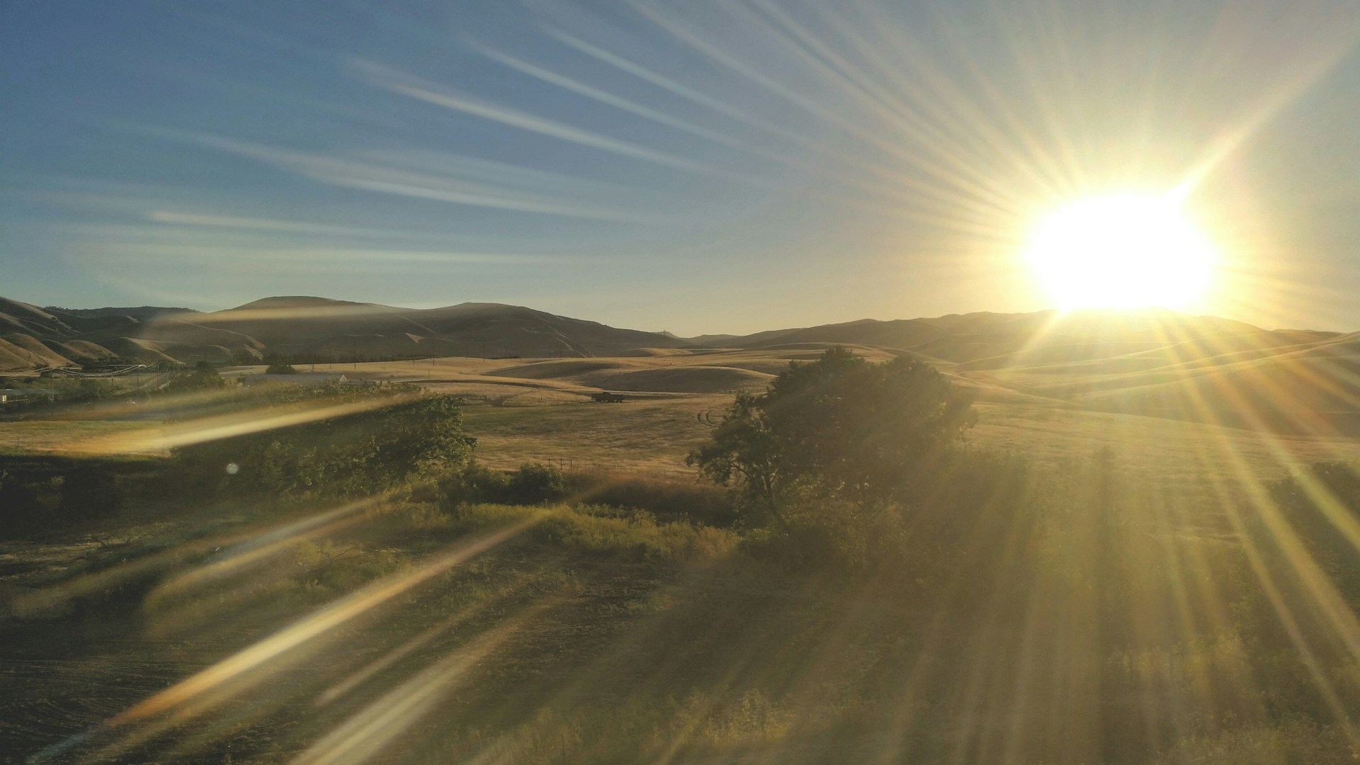 woman wearing yellow long-sleeved dress under white clouds and blue sky during daytime