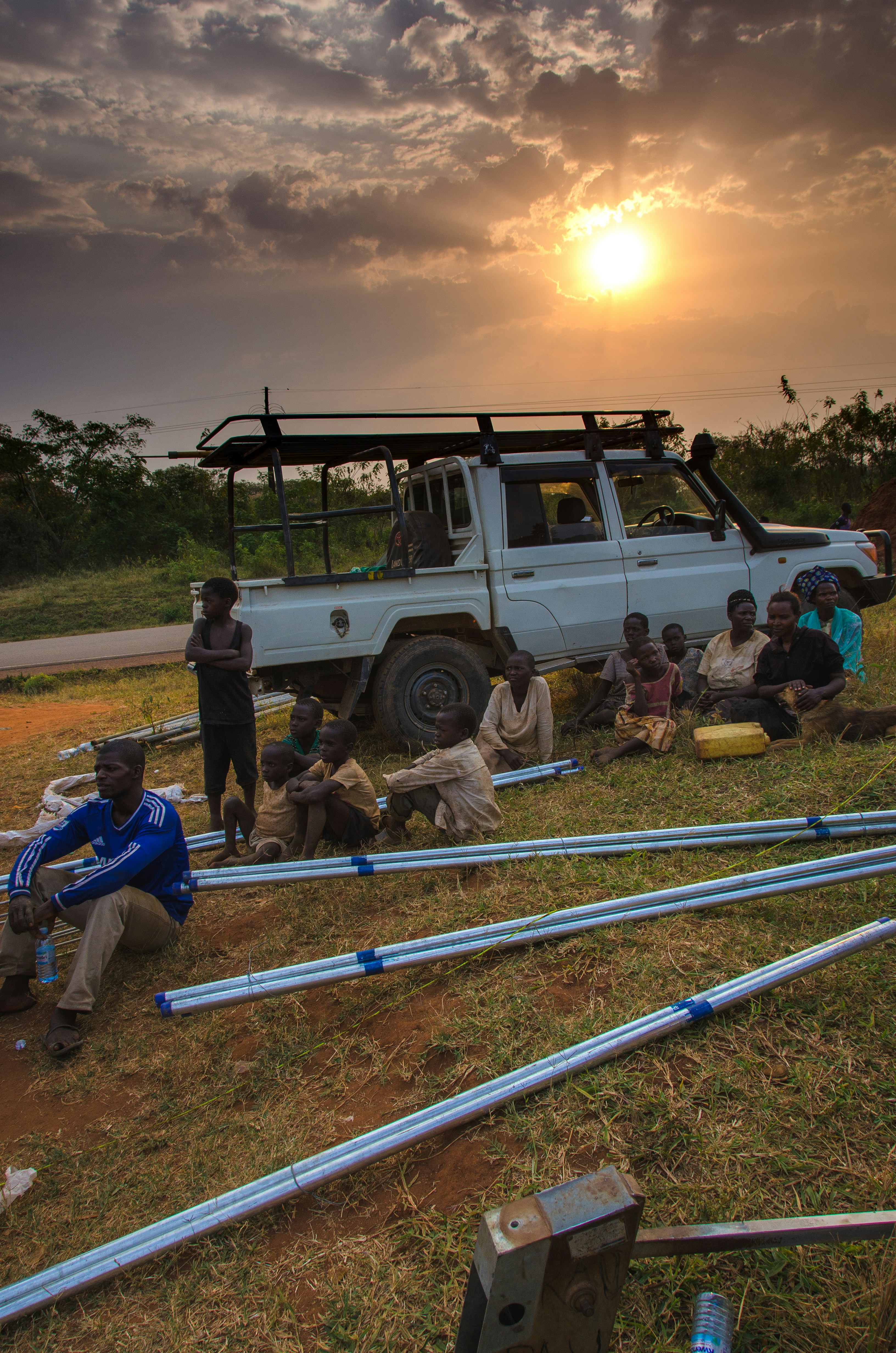 people sitting by truck during golden hour