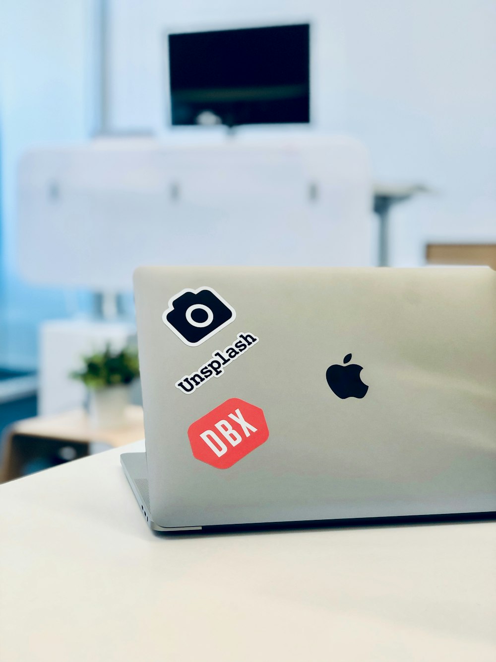 silver MacBook on table