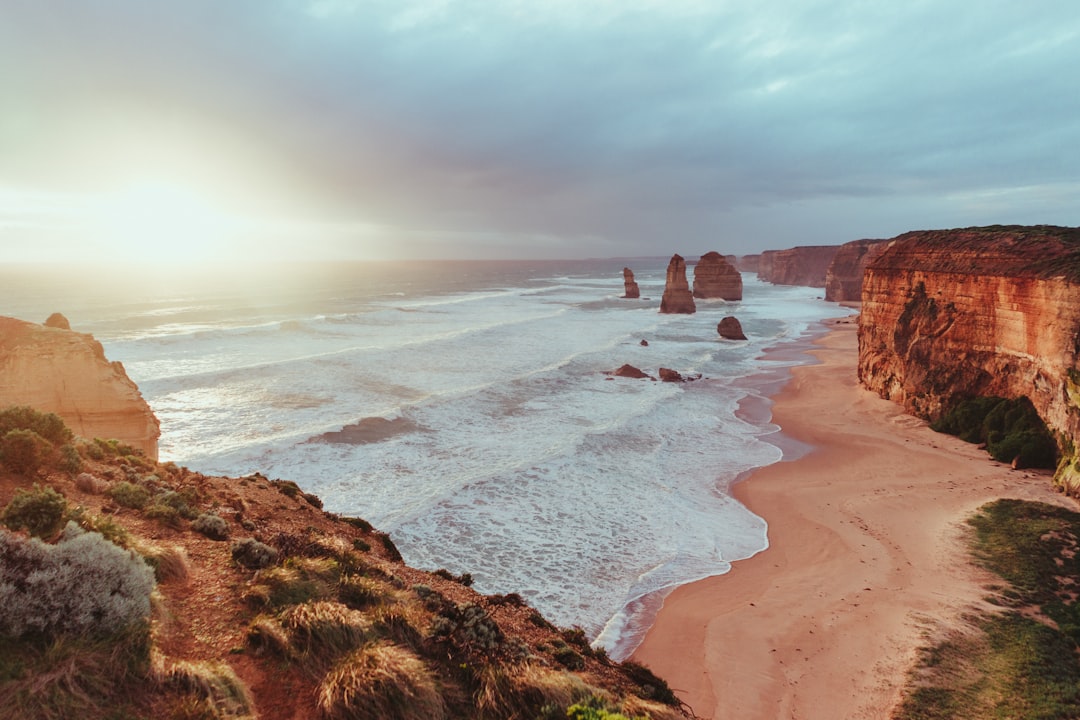 rock formation near ocean, Twelve Apostles at Sunset