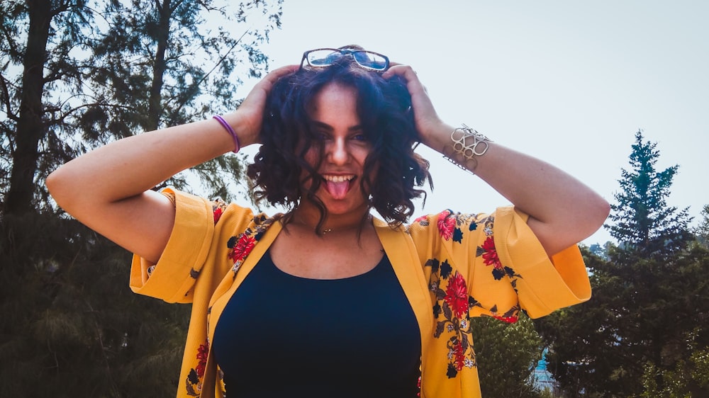 woman in black top showing tongue