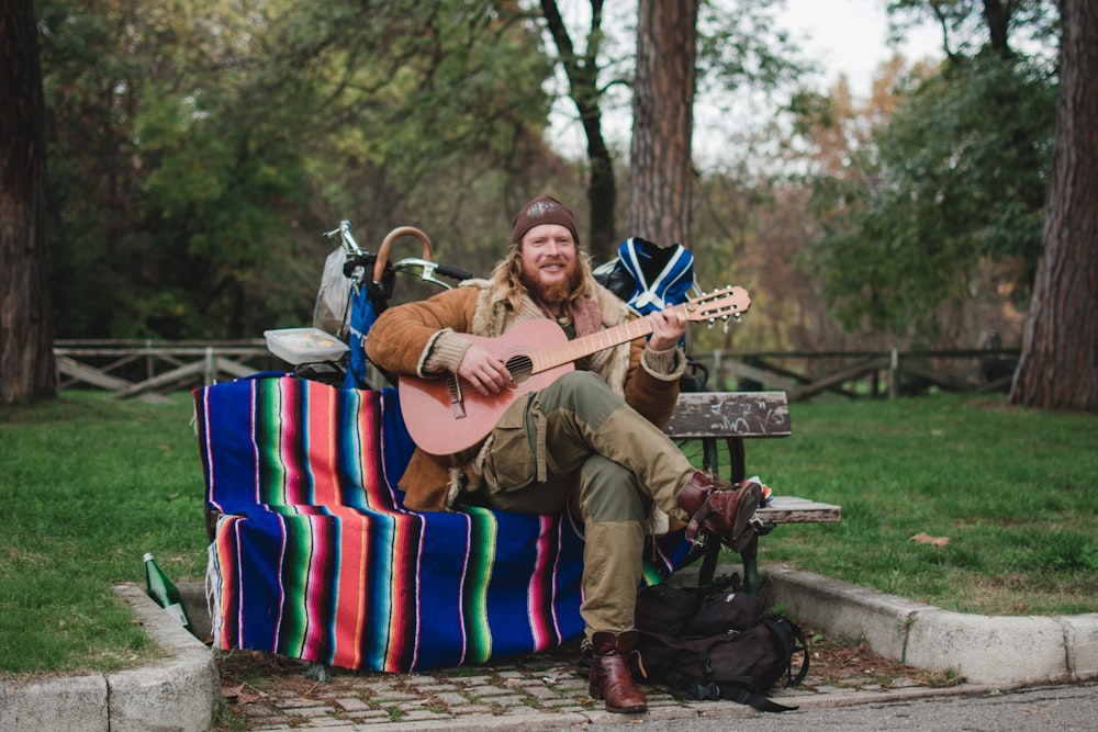 man playing guitar outdoors