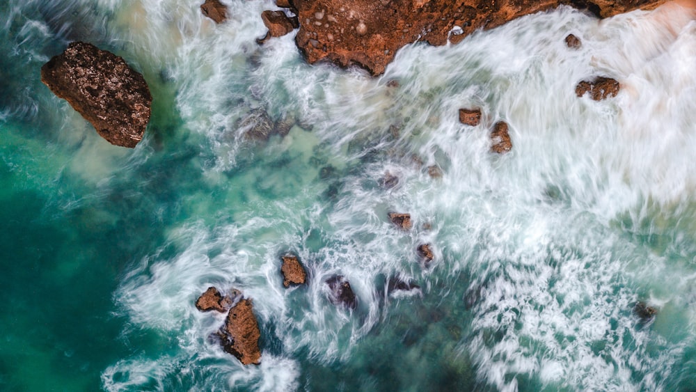 body of water with rock formation wallpaper