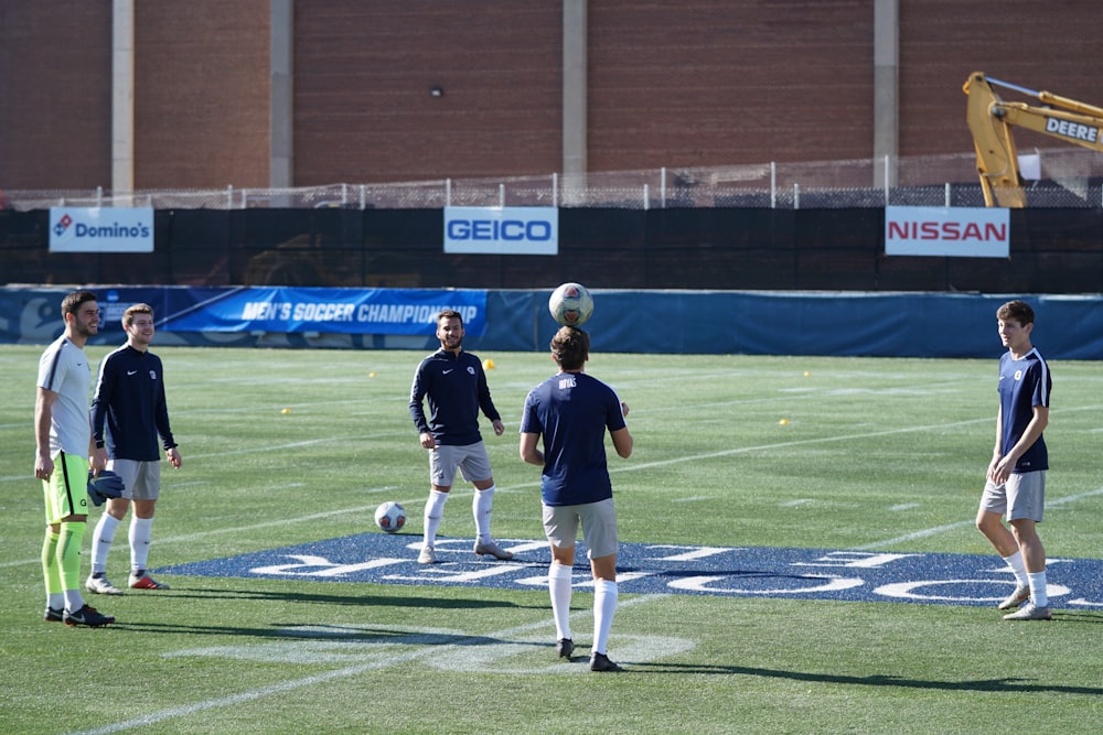 men playing soccer during daytime