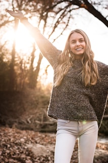 woman raising right hand during daytime