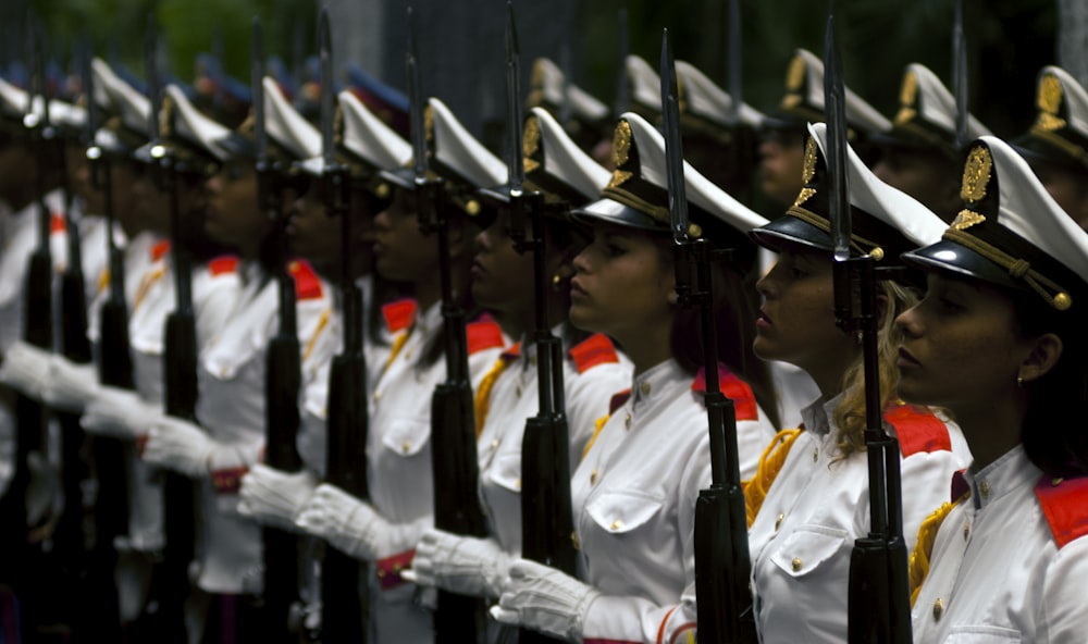 women lined up holding rifle