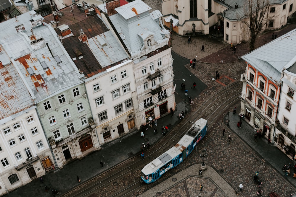 train on rail between buildings