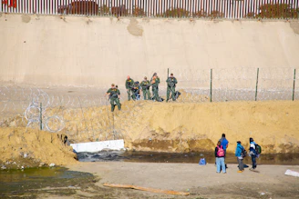four person standing near monuntain
