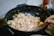 A close-up of a frying pan with a delicious meal being prepared.