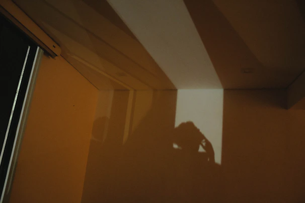 A conceptual photo with dramatic shadows and geometric shapes creating a mysterious mood.