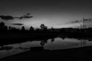 Cover of a poetic book with a serene landscape at dusk