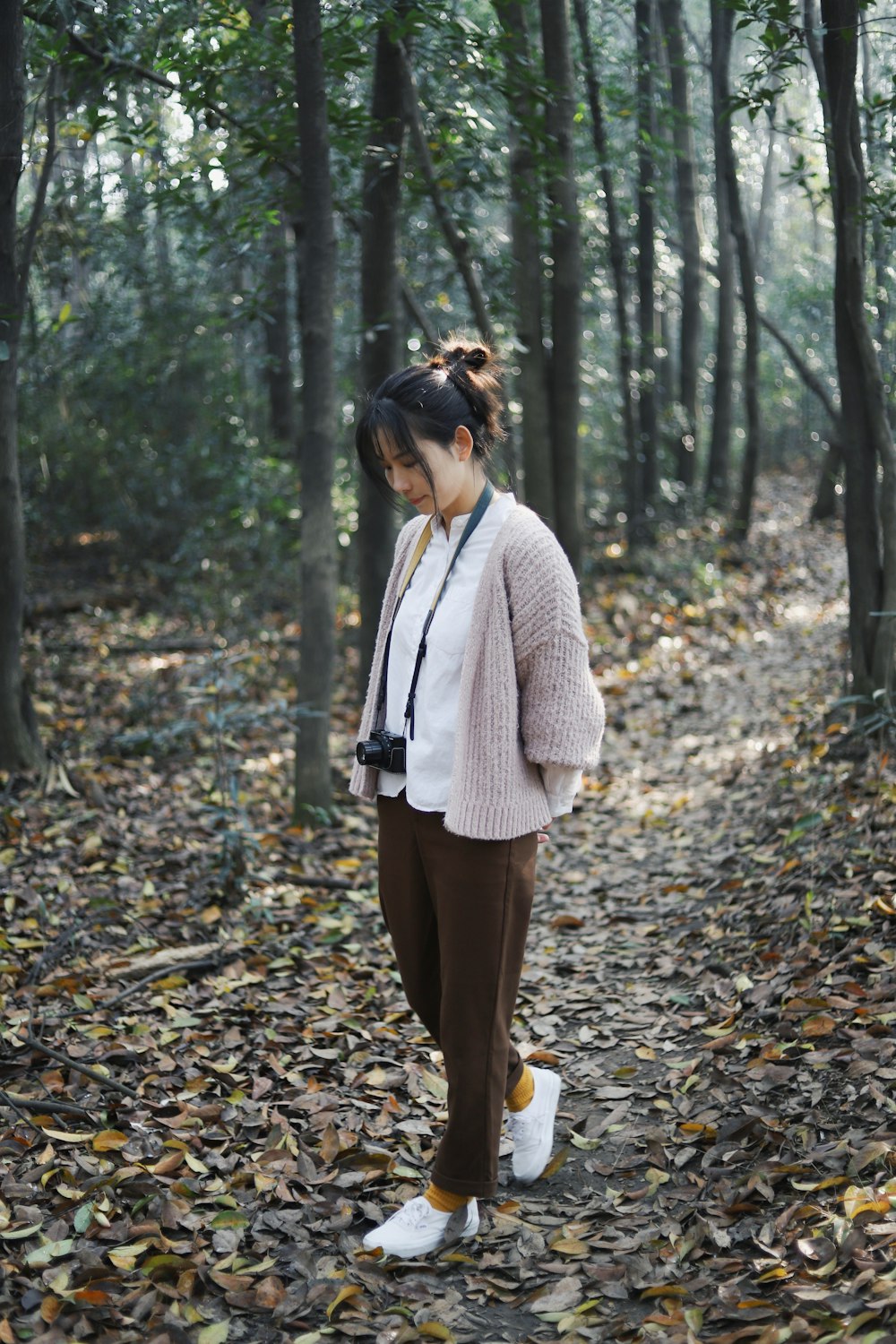 woman walking near trees