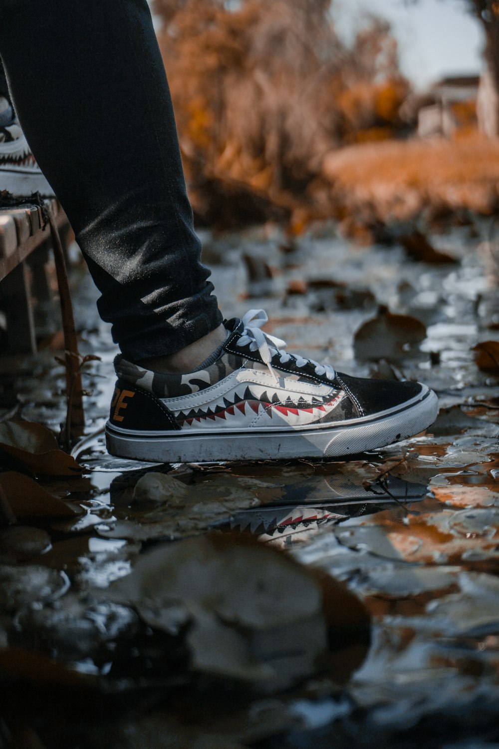 person wearing black and white low-top sneaker