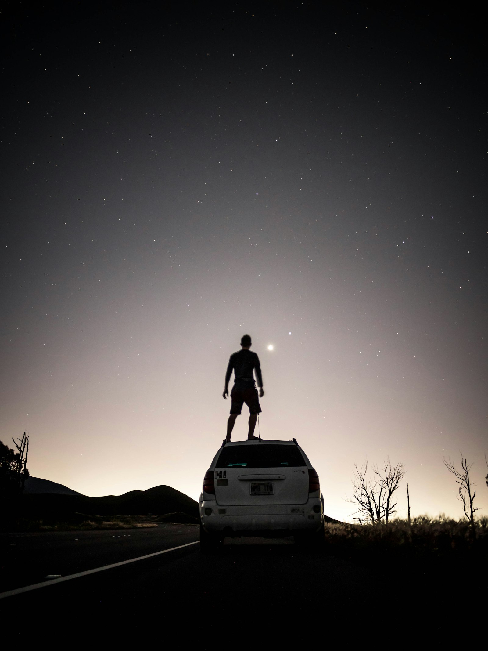 Panasonic Lumix G 14mm F2.5 ASPH sample photo. Man standing on suv photography