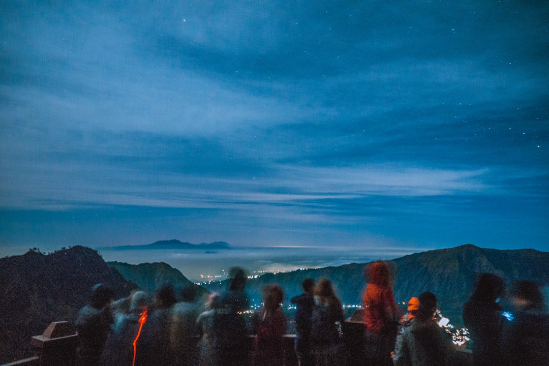 people standing near mountain