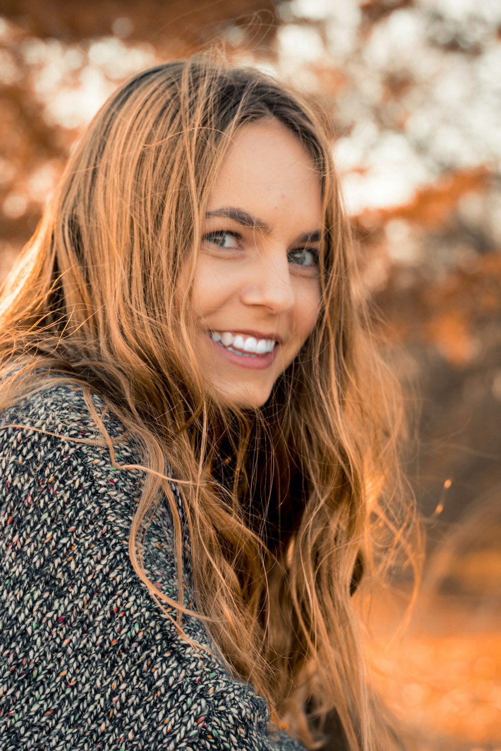 smiling woman wearing gray dress