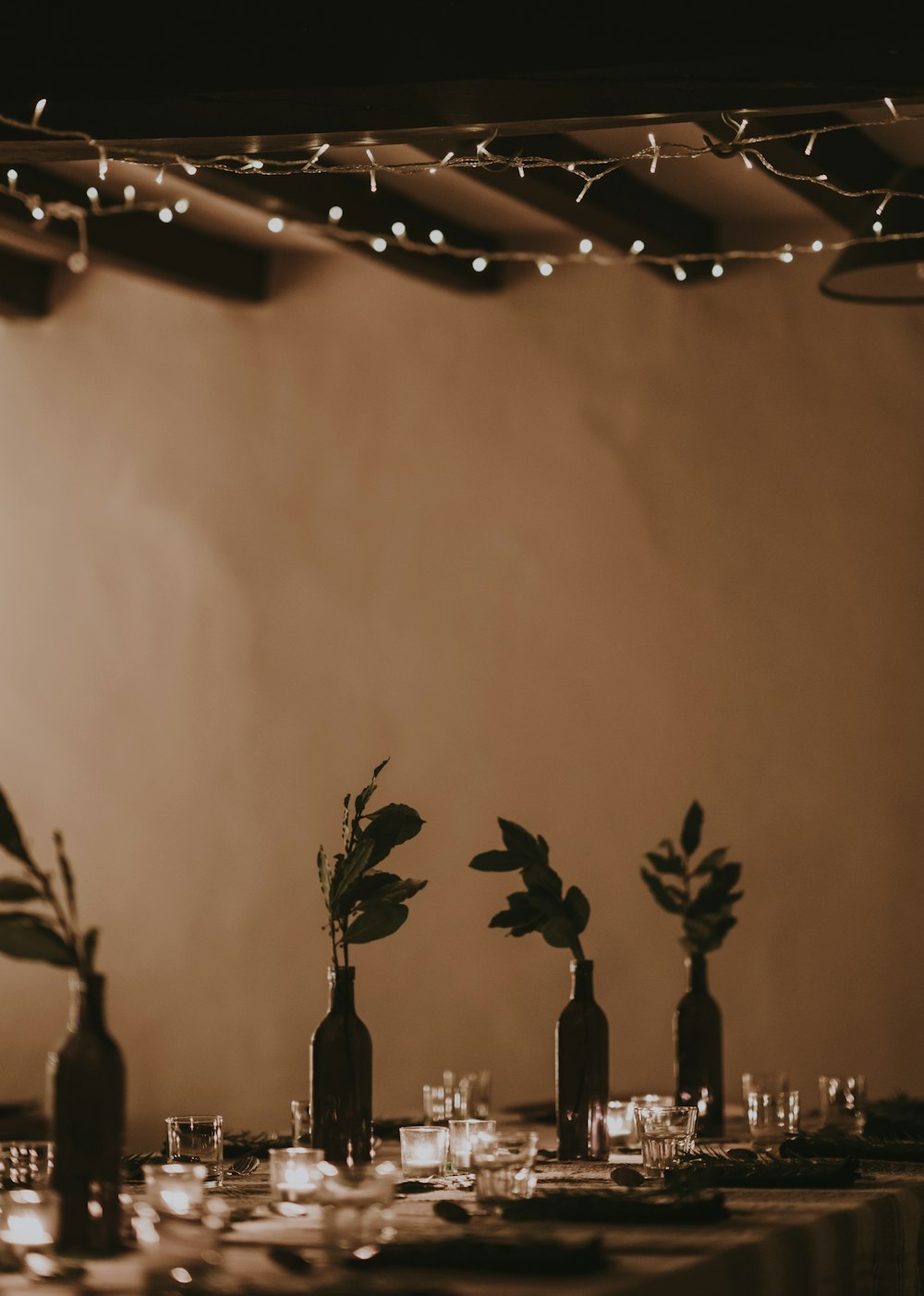 dining table with flowers near wall