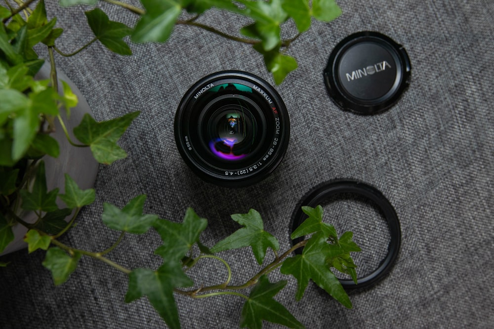 flat lay photography of camera lens on gray mat