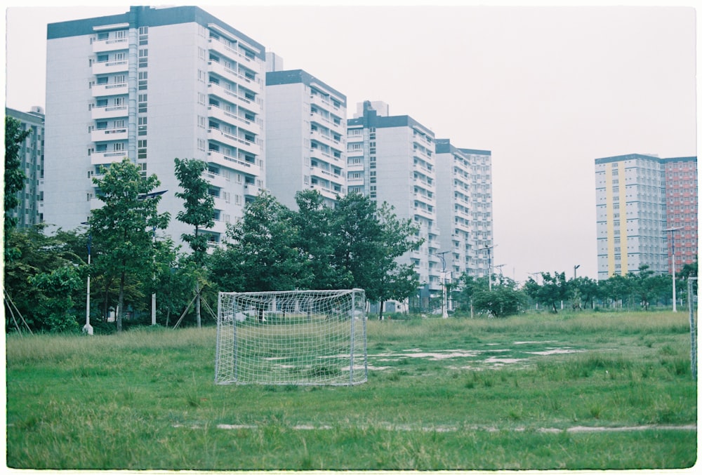 in distant photo of white sports goal on grass field