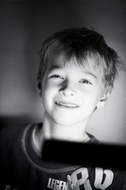 A warm, inviting photo of a child smiling gently, symbolizing hope and care.