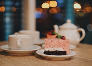 slice of cake near cup on table