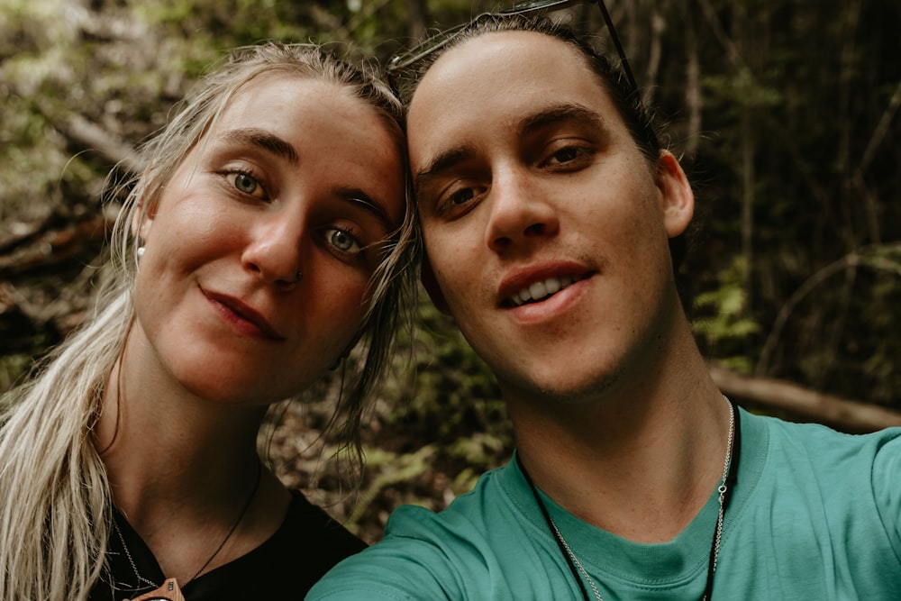 woman and man taking self portrait under shade of tree at daytime