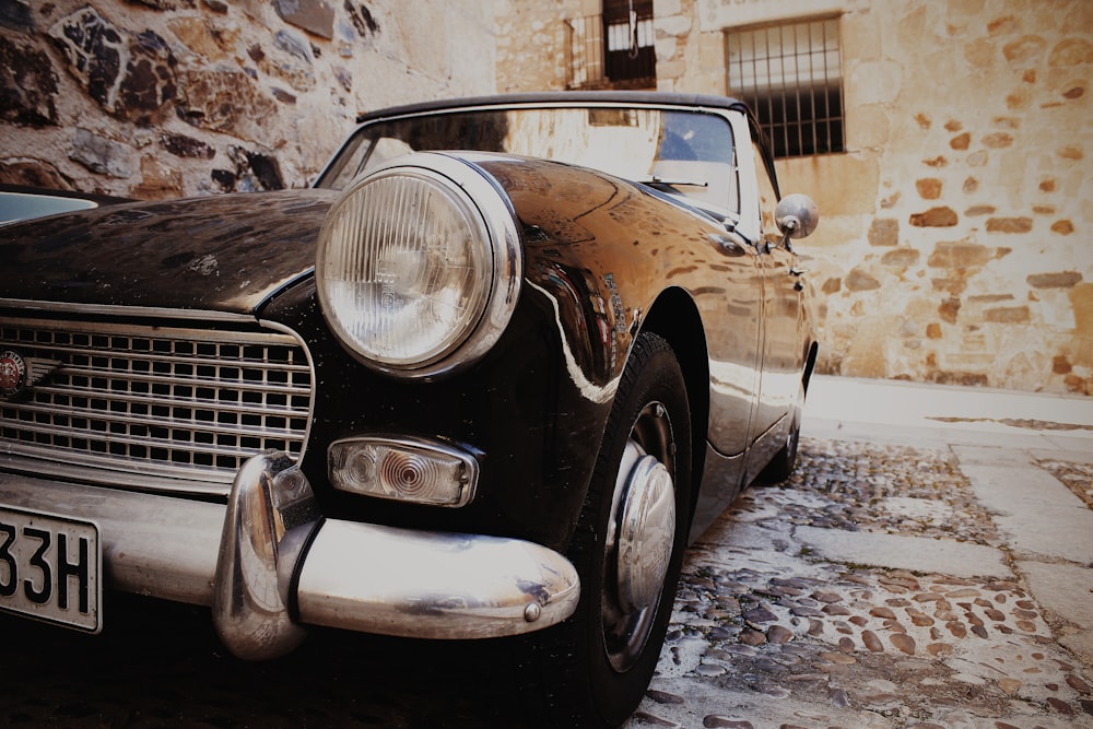 classic black vehicle parked beside building