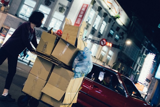 woman near red vehicle at nighttime