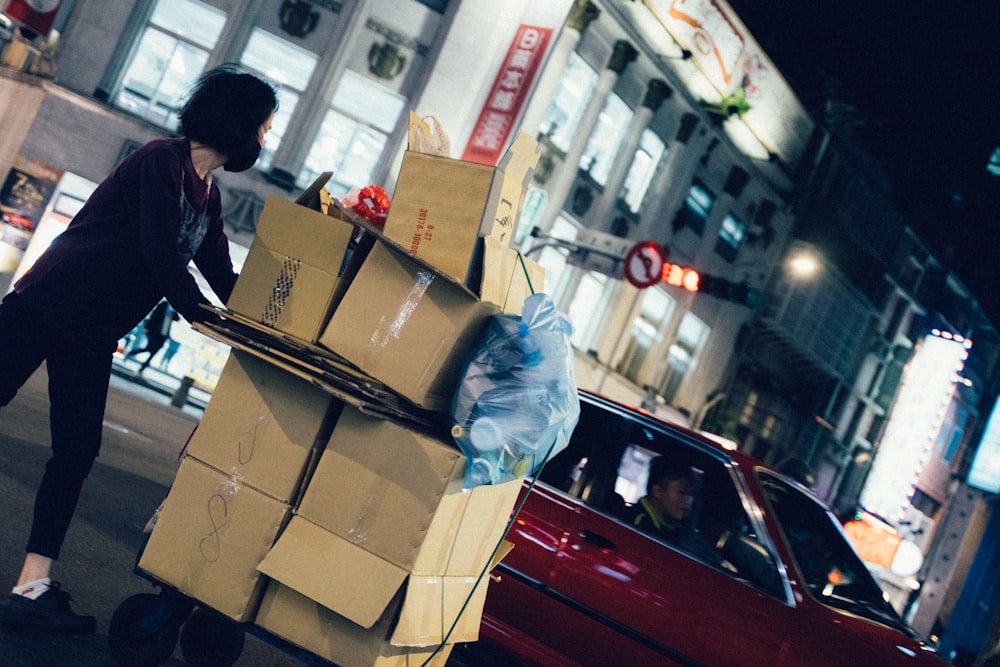 woman near red vehicle at nighttime