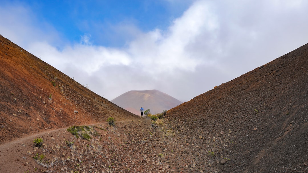 person between brown mountains