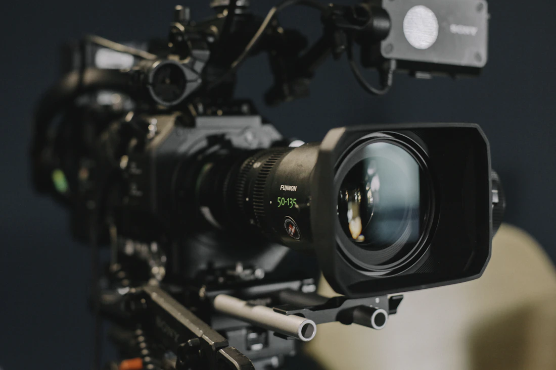 A cinematographer framing a shot, part of the production behind every custom build.