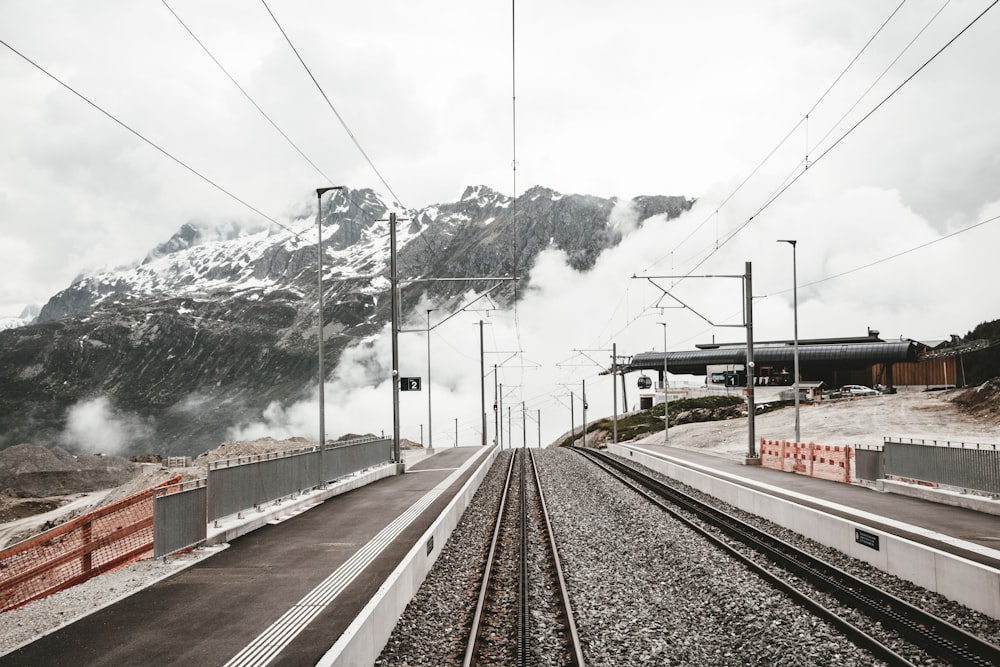 grey railway near houses