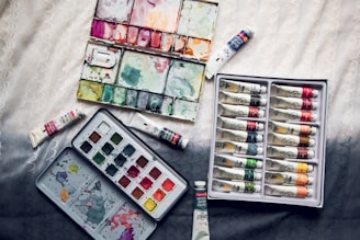 assorted-color soft-tube lot on white textile