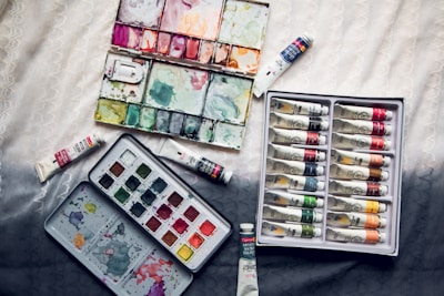 assorted-color soft-tube lot on white textile