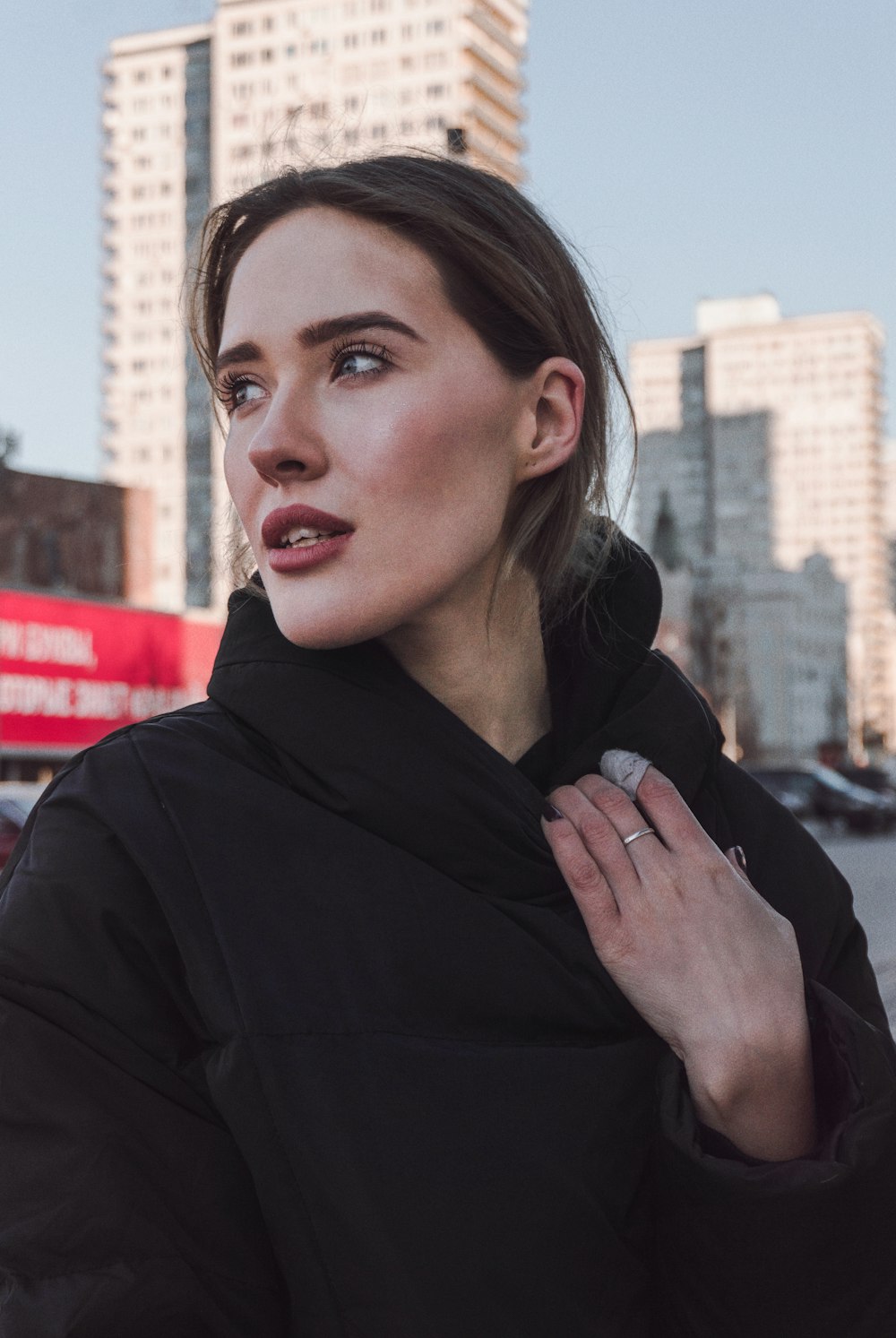 woman wearing jacket near buildings