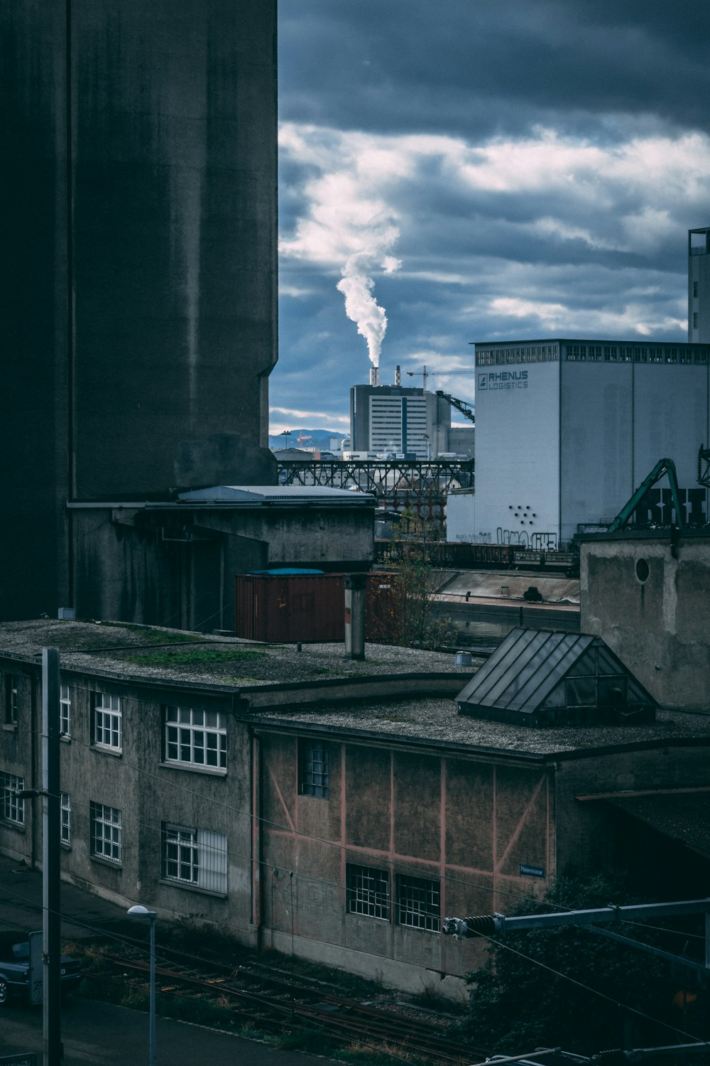 brown concrete house under cloudy sky