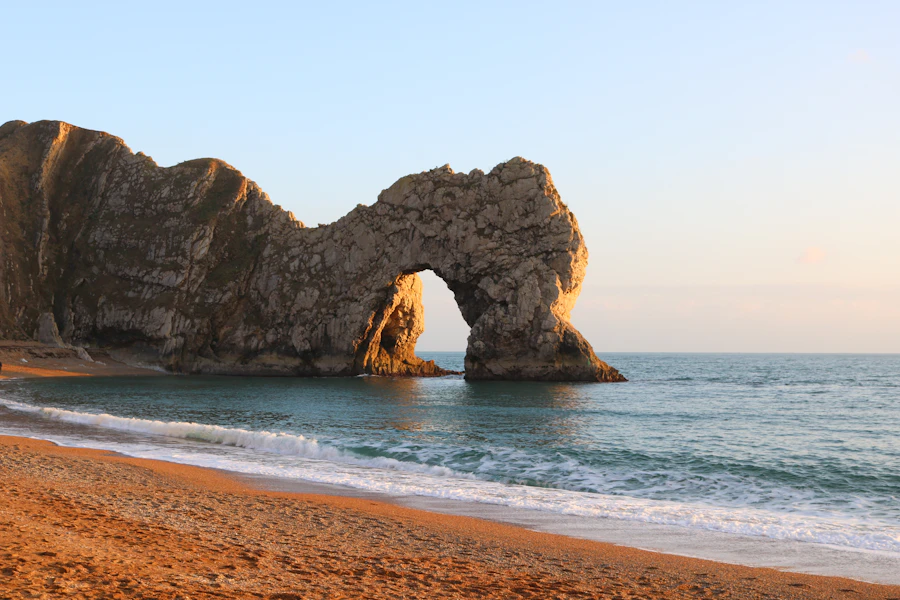 The limestone arch of Durdle Door at sunset on the Dorset coast
