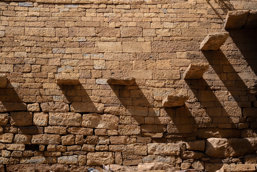 brown brick wall with stairs